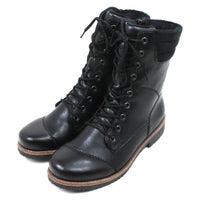 Pair of black leather boots with brown soles on a white background