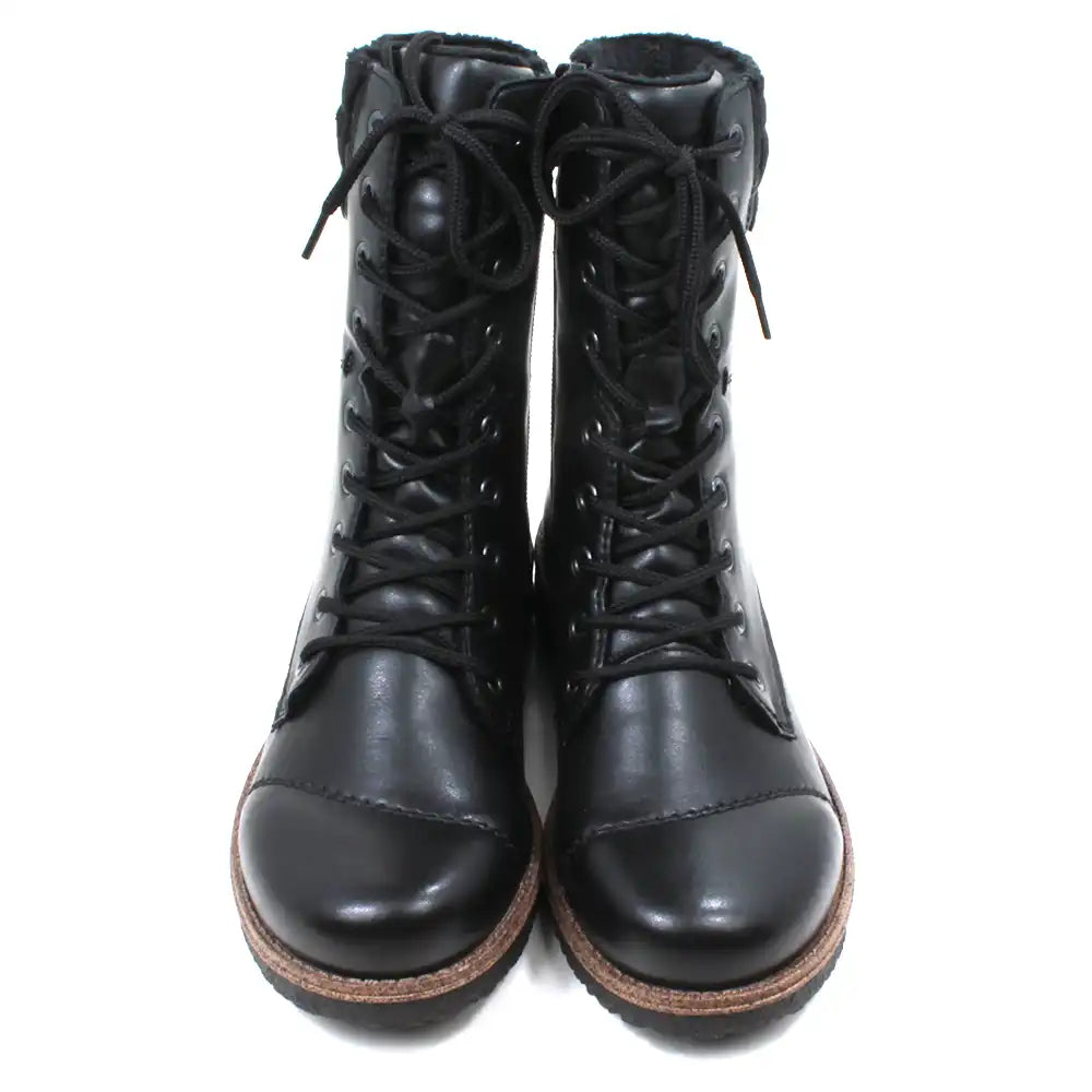 Pair of black leather boots with brown soles on a white background