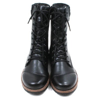 Pair of black leather boots with brown soles on a white background