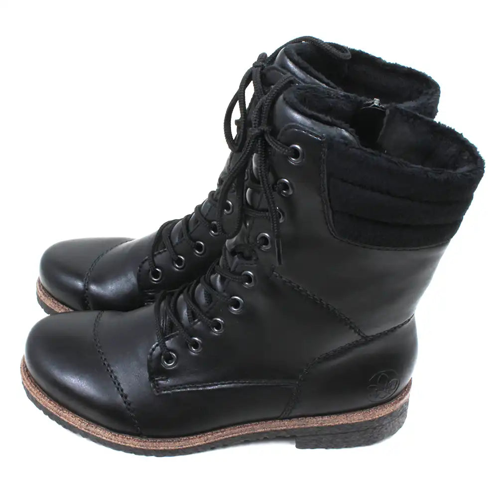 Pair of black leather boots with brown soles on a white background