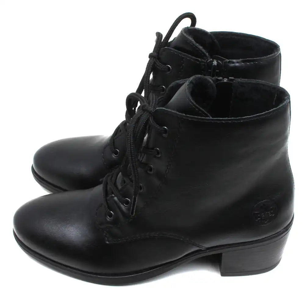 Rieker Victorian styled laced ankle boots with zip up fitting. Black with almond toes and medium heels. Embossed Rieker logo on heels. Side view.