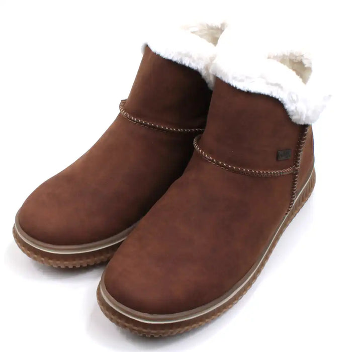 Rieker tan coloured suede look boots with visible stitching seams near the ankles. Fur ankle cuffs leading into a furry interior. Light tan rubber soles. Angled view.