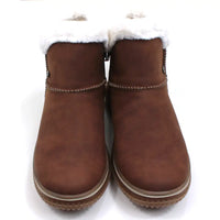 Rieker tan coloured suede look boots with visible stitching seams near the ankles. Fur ankle cuffs leading into a furry interior. Light tan rubber soles. Front view.