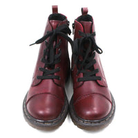 Pair of maroon combat boots with black laces on a white background