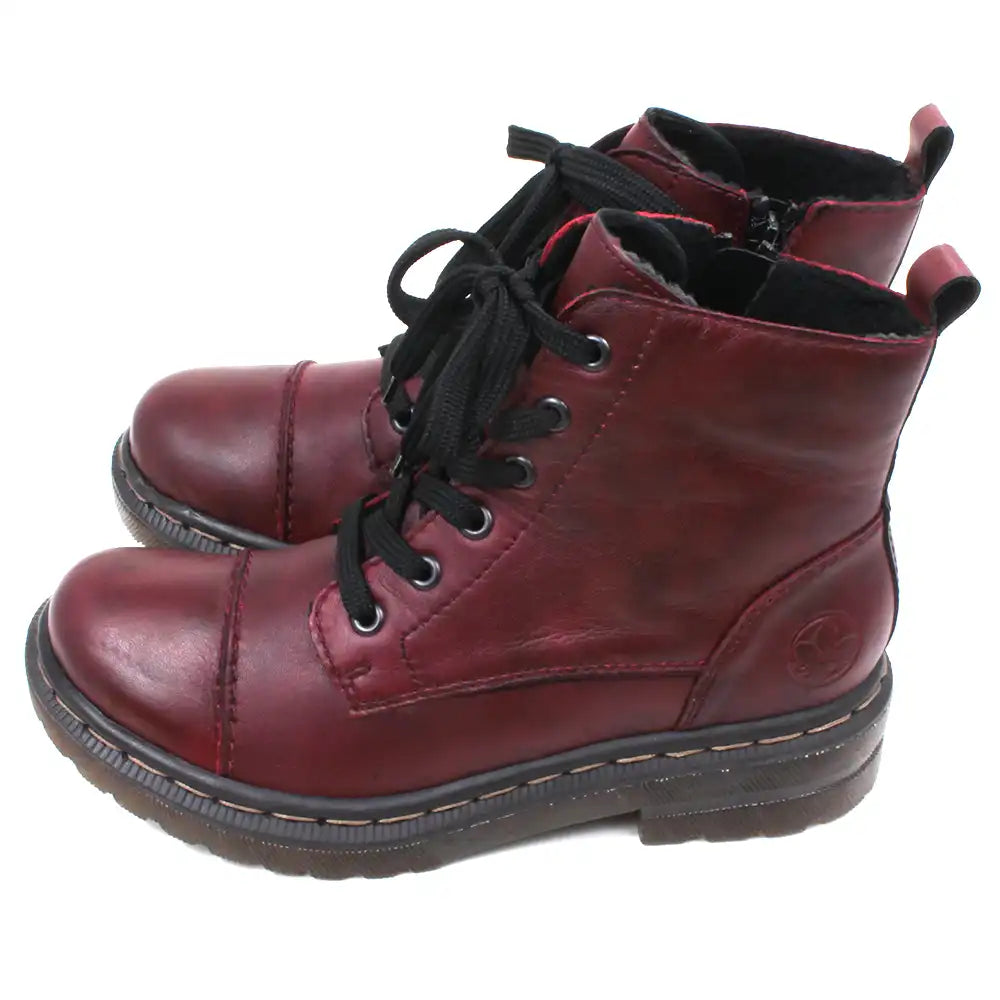 Pair of maroon combat boots with black laces on a white background