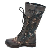 Rieker khaki foliage pattern calf boots. 9 hole lacing down the front. Strap with buckle around the upper calf. Brogue punch pattern toe caps. Low heels. Zip fitting. View showing single boot and  zip fastening from sole to the top of the calf.