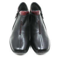 A pair of black leather ankle boots with red contrast stitching and a dark red inner lining, shown from a front-facing perspective on a white background.