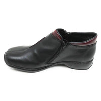 A black leather slip-on shoe with a side zipper and a contrasting burgundy inner collar, shown from a side profile on a white background.
