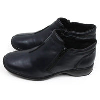 Rieker navy blue shoes. Zip fitting. Simple laceless design. Black soles with low heels. Side view.