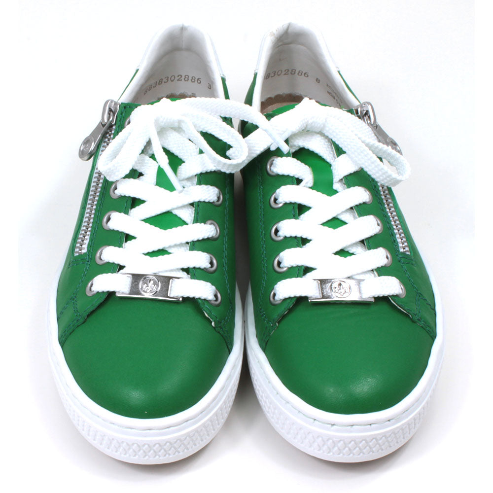 Rieker green trainers with white rubbers soles. White laces adjustment with silver Rieker badge on the bottom lace rung. Side zips for fitting. Front view.