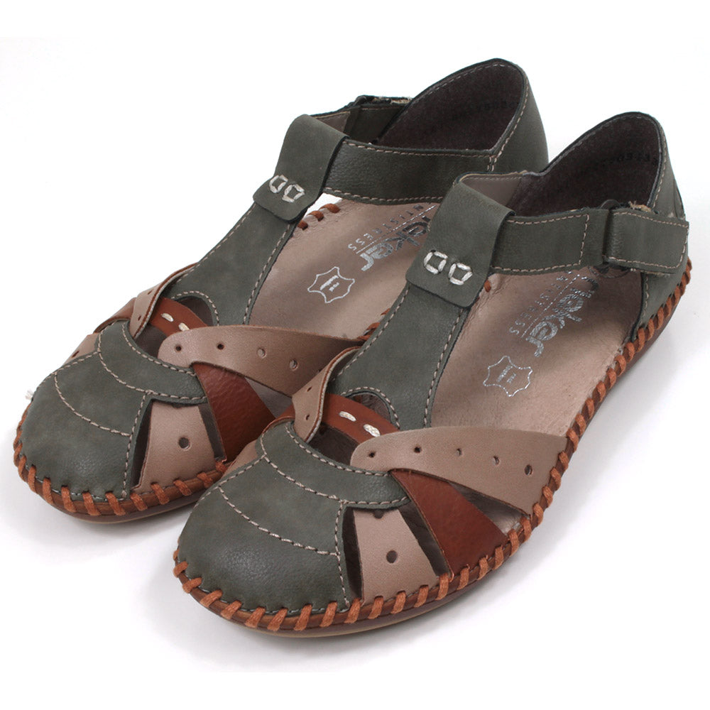 Rieker sandals in green, tan and beige combination. Velcro fitting and adjustment over the ankle. Angle view.