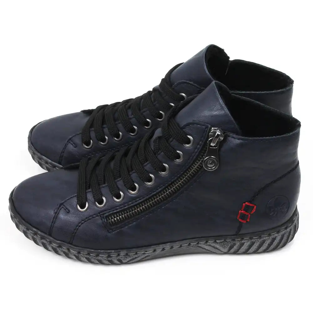 Pair of navy ankle boots with zippers and adjustment laces. Side view.