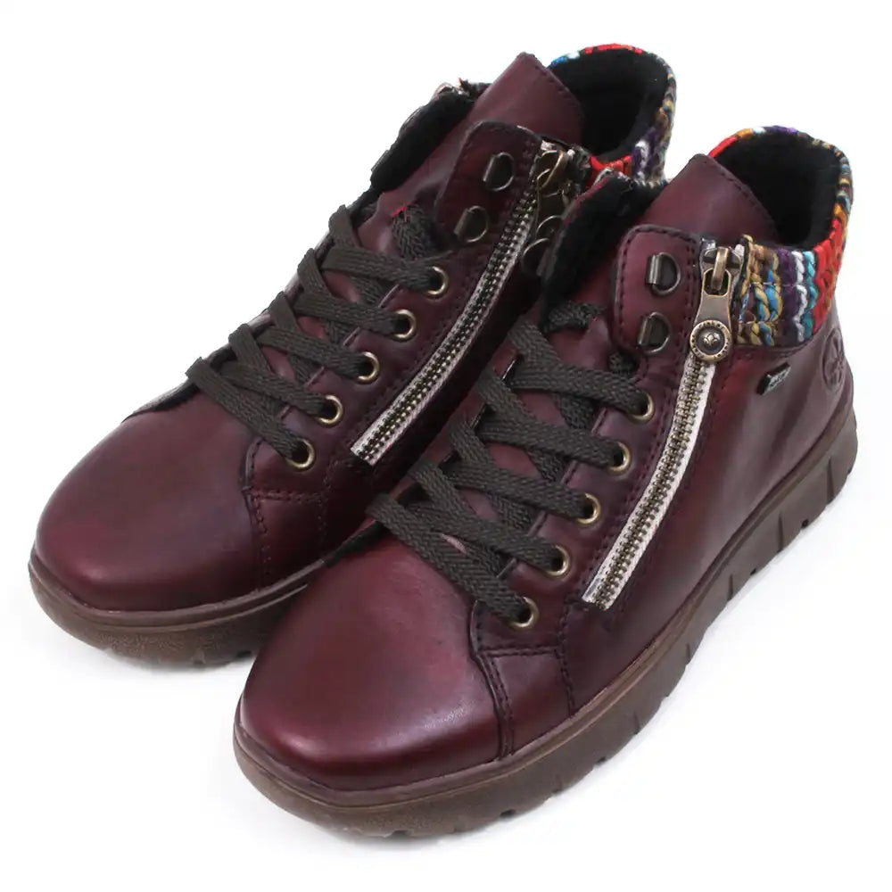 Maroon ankle boots with zippers and knitted ankle cuffs on a white background