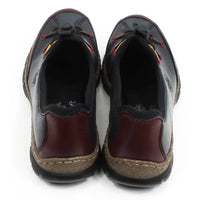 Rieker dark blue leisure shoes. Black fabric padding around the ankle and over the top of the tongue. Blue, yellow and brown details around the first,third and fifth lace eyes. Burgundy panels around the shoe backs.  Fastens with elastic laces which are adjusted with a push button gripper. Cork and black rubber soles. Back view.