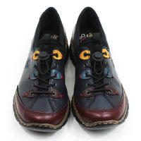 Rieker dark blue leisure shoes. Black fabric padding around the ankle and over the top of the tongue. Blue, yellow and brown details around the first,third and fifth lace eyes. Burgundy strips around the toes.  Fastens with elastic laces which are adjusted with a push button gripper. Cork and black rubber soles. Front view.