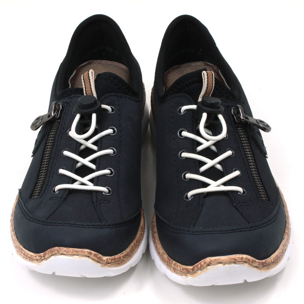 Rieker navy blue trainers. White laces and zip down outside of the foot. White soles with cork effect detail. Shoes shown from the front..