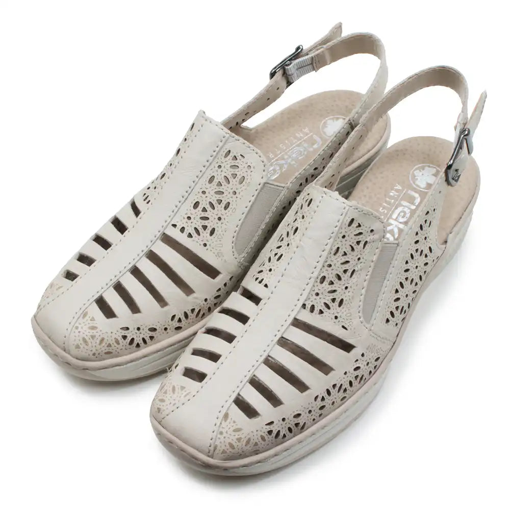 Beige cut out pattern sandals with back straps on a white background.
