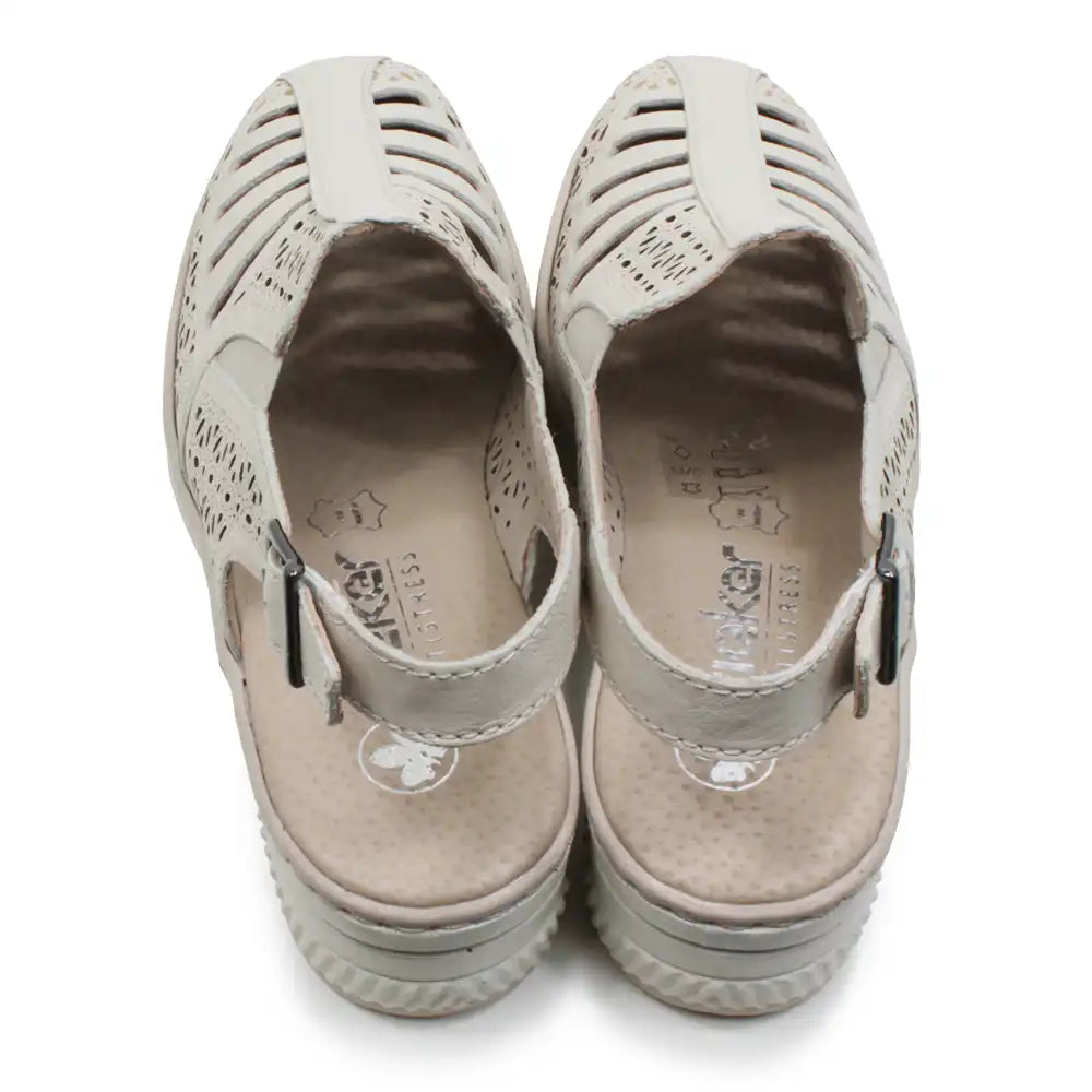 Beige cut out pattern sandals with back straps on a white background.