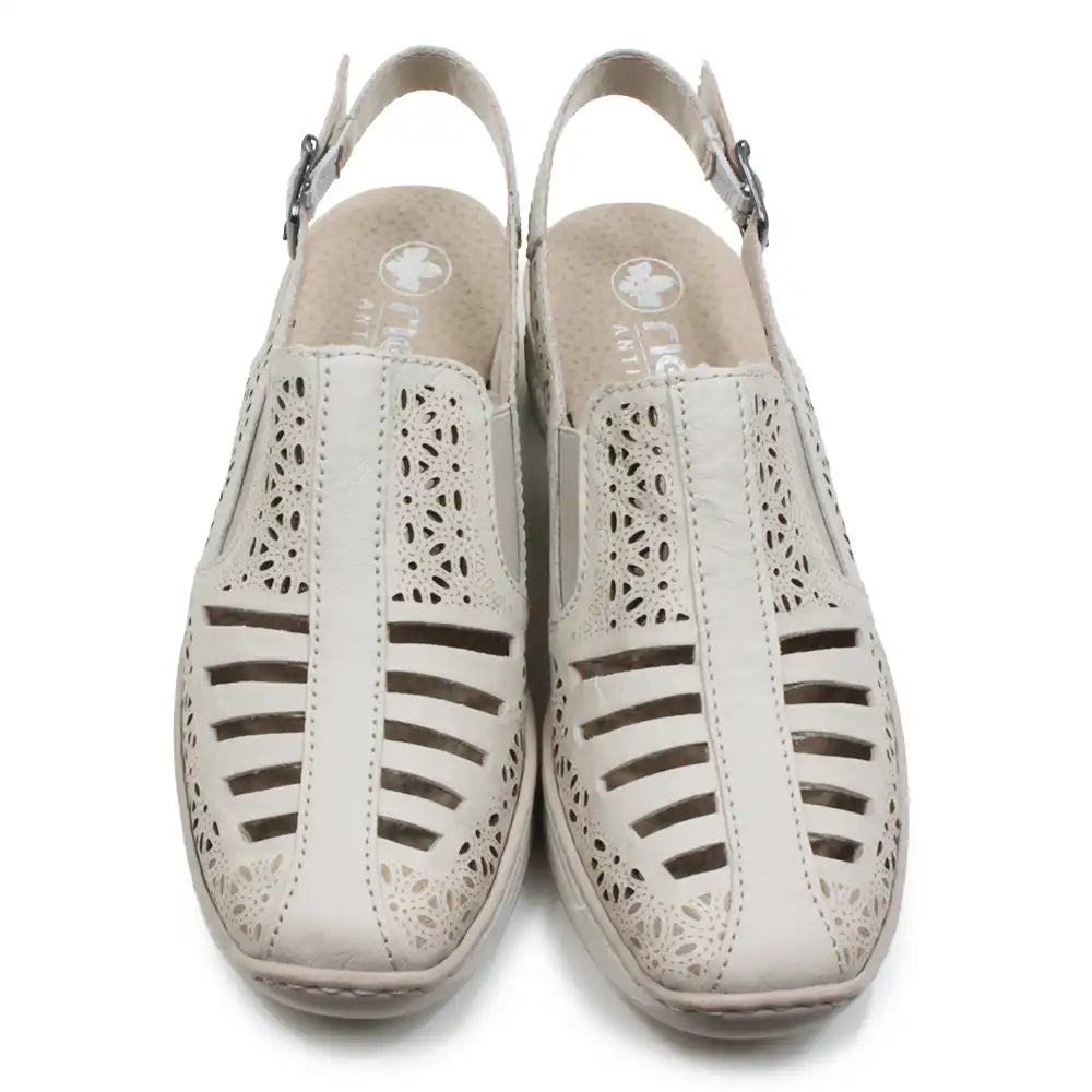 Beige cut out pattern sandals with back straps on a white background.