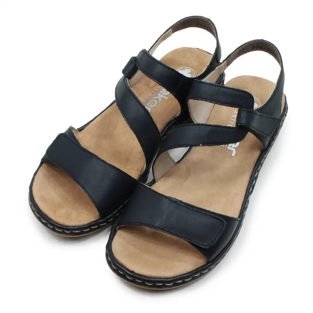 Dark blue strappy sandals on a white background.