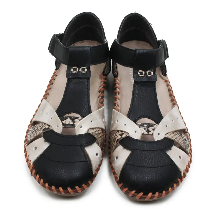 Pair of black and snakeskin sandals with patterned soles on a white background