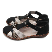 Pair of black and snakeskin sandals with patterned soles on a white background