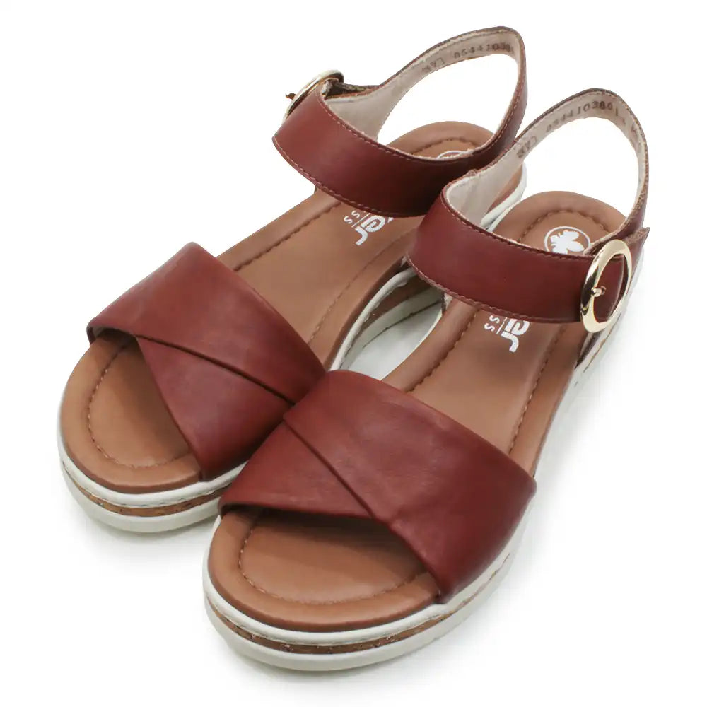 Brown sandals with criss-cross straps on a white background