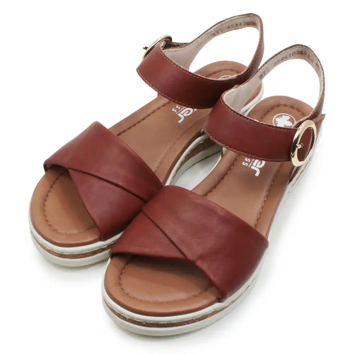 Brown sandals with criss-cross straps on a white background