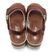 Pair of brown sandals with a visible brand logo on a white background
