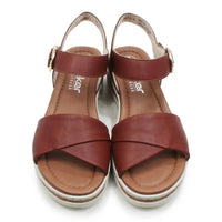 Pair of brown sandals with a visible brand logo on a white background