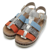 Colorful sandals with patterned straps on a white background