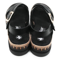 Pair of black sandals with jute sole on a white background