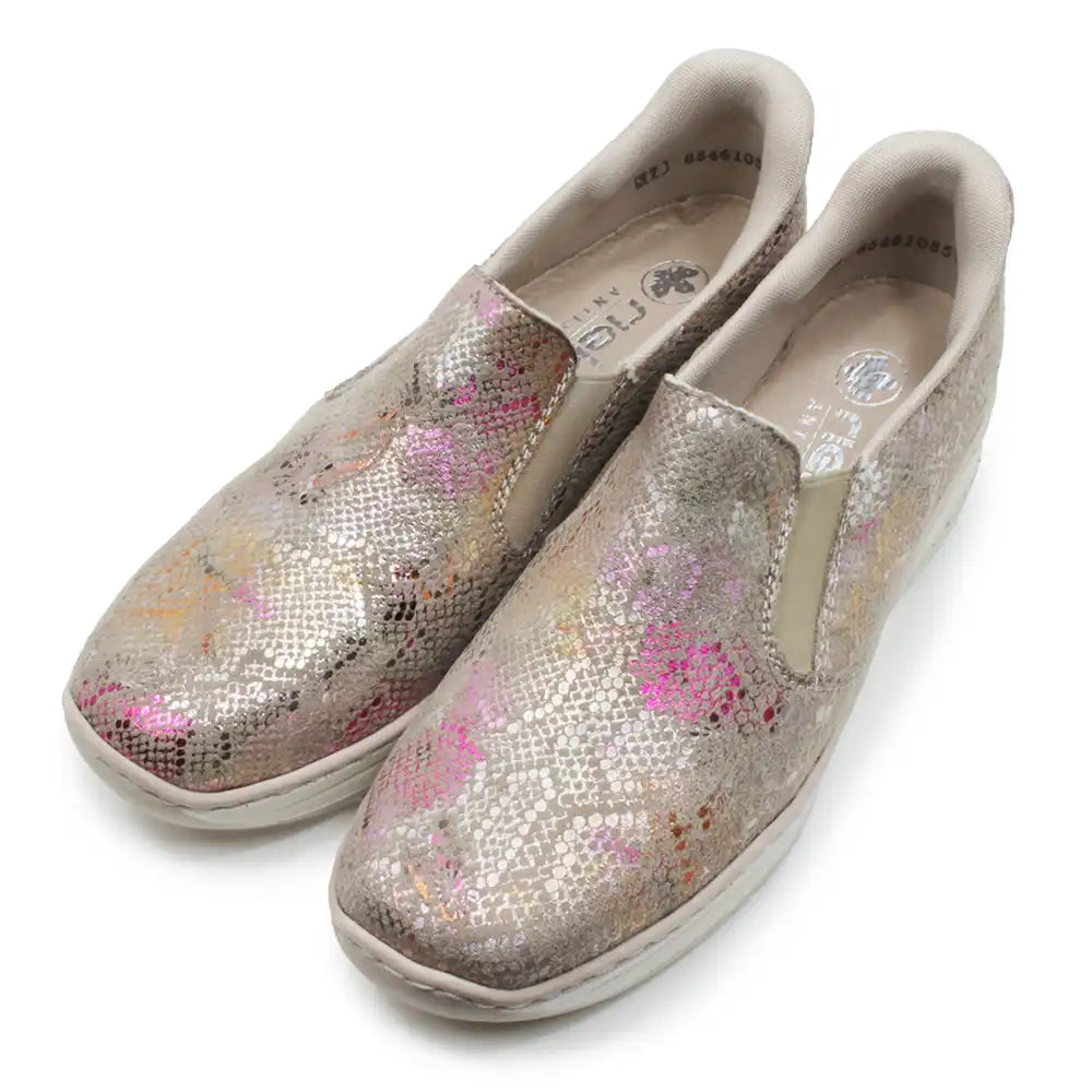 Pair of glittery slip-on shoes with floral pattern on a white background