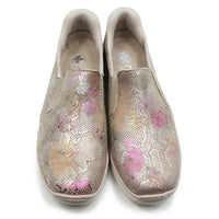 Pair of glittery slip-on shoes with floral patterns on a white background
