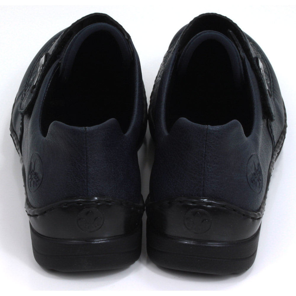 Rieker dark blue Velcro fastening shoes with elasticated patterned panel. Flats with slight wedge heels. Back view.