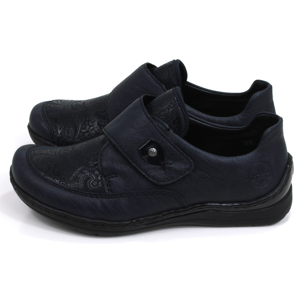 Rieker dark blue Velcro fastening shoes with elasticated patterned panel. Flats with slight wedge heels. Side view.