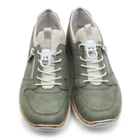 Pair of green sneakers with white laces on a white background