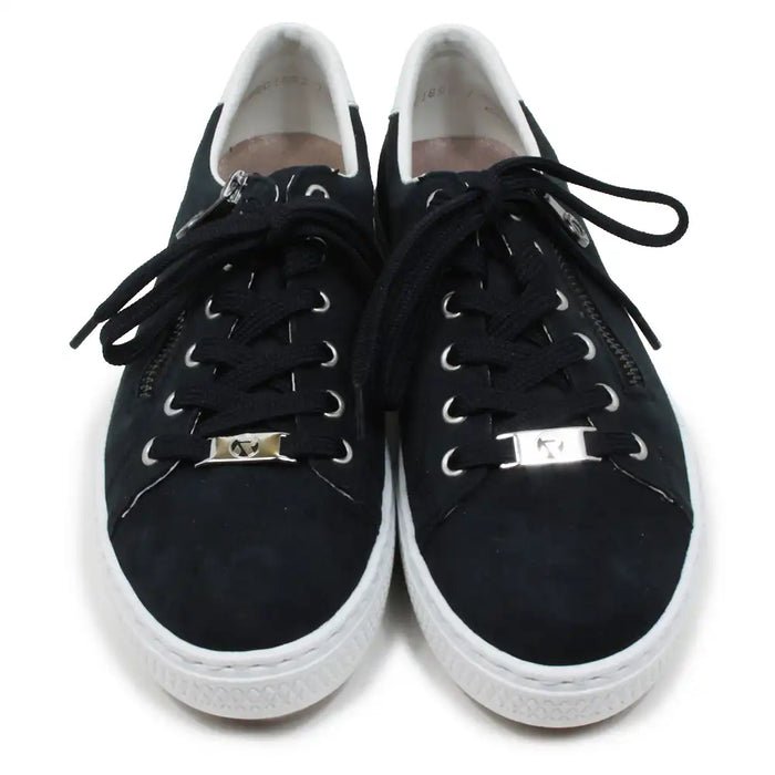 Navy sneakers with white soles on a white background