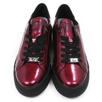 Pair of patent red shoes with black laces on a white background.