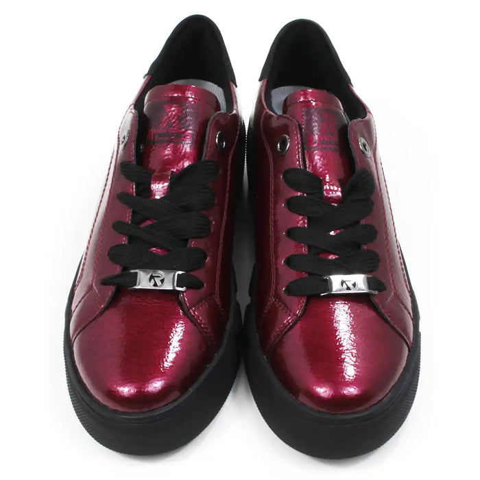 Pair of patent red shoes with black laces on a white background.