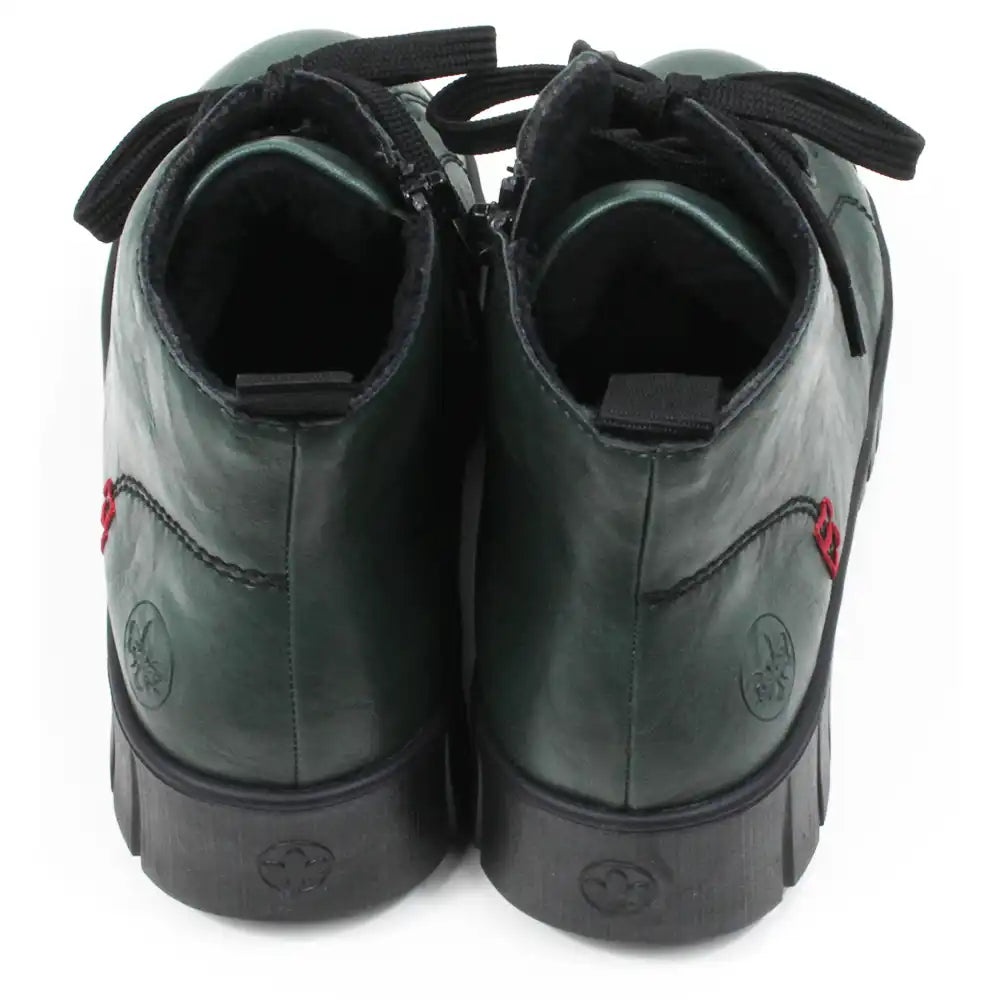 Green ankle boots with black laces on a white background. Back view.