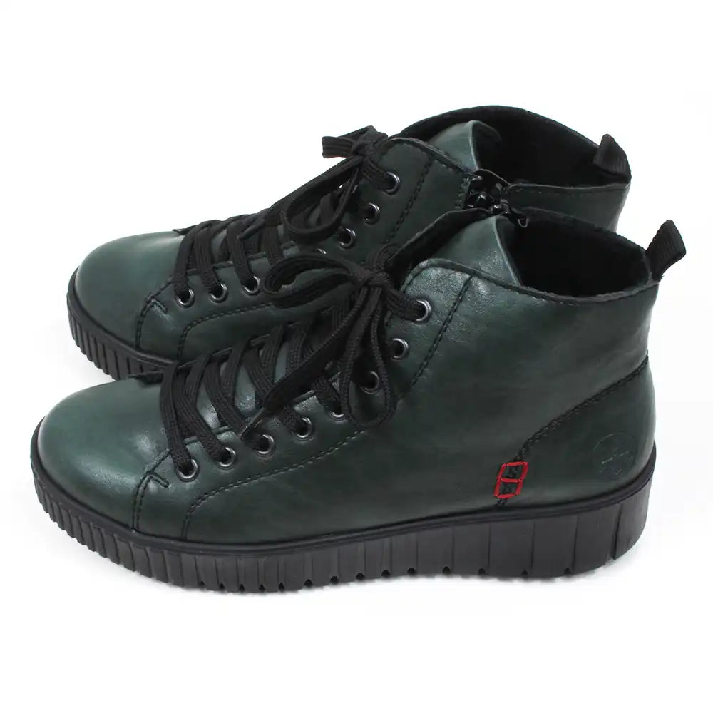Green ankle boots with black laces on a white background. Side view.