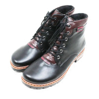 A pair of lace-up ankle boots in black and dark brown leather with silver metal eyelets, black laces, and a tan welted sole, shown on a plain white background.