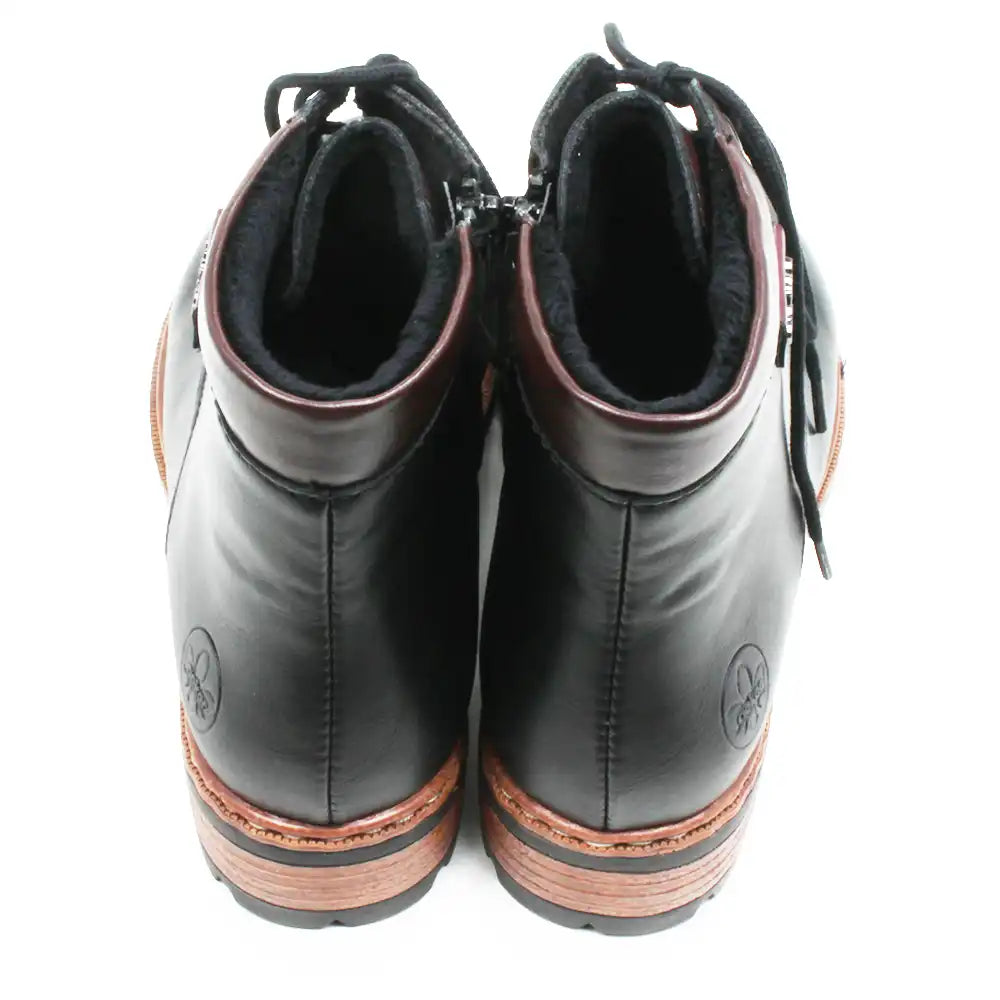 A pair of black leather ankle boots with black laces, black zippers, and a brown wood-grain style midsole, shown from a top-down view on a white background.