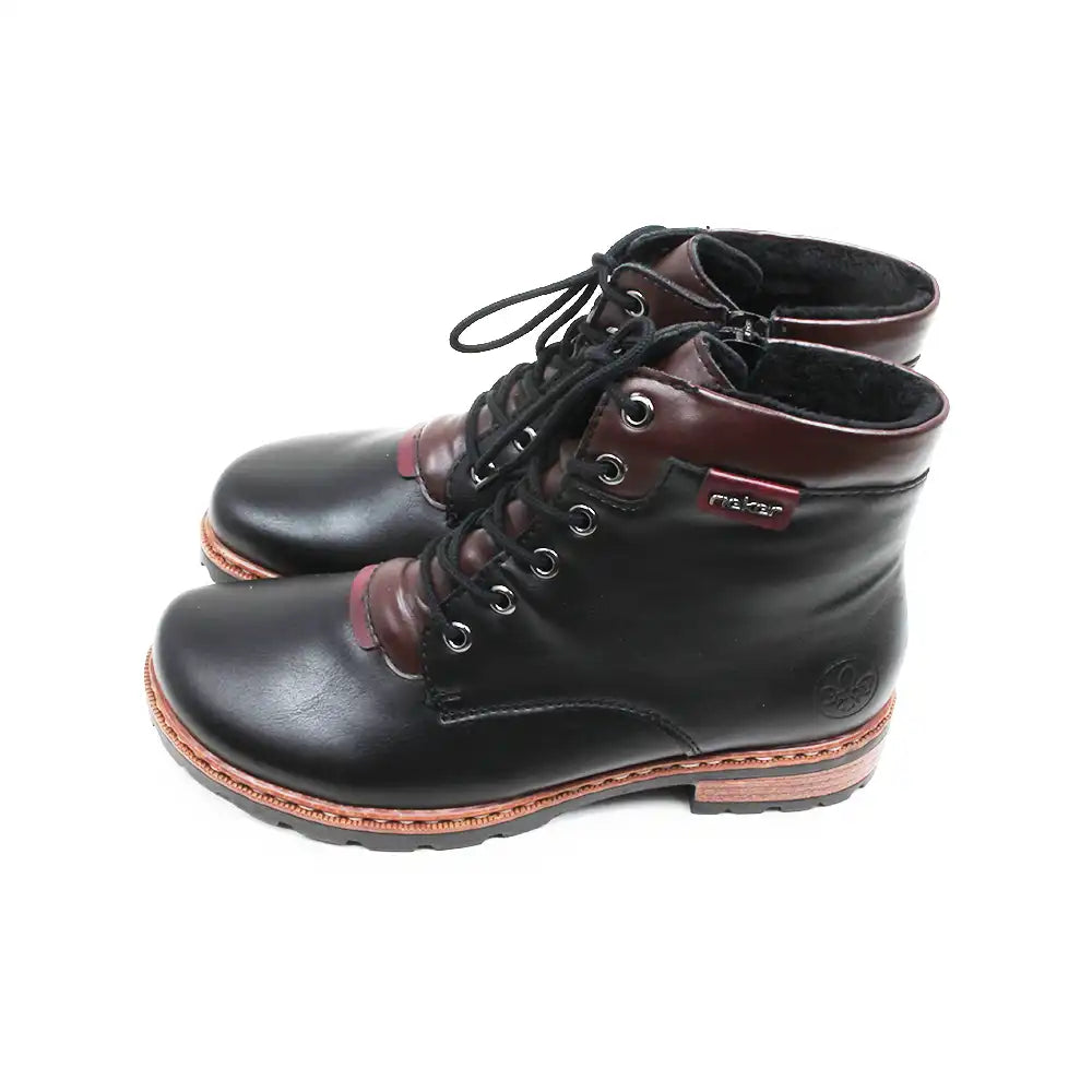 A pair of lace-up ankle boots with black leather uppers, dark brown leather panels at the collar and toe, black laces, and a light brown sole, shown against a plain white background.