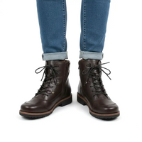 A pair of dark brown leather lace-up ankle boots worn with cuffed blue jeans, shown from the front against a plain white background.