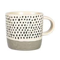 Mug with black dot pattern and gray base on a white background
