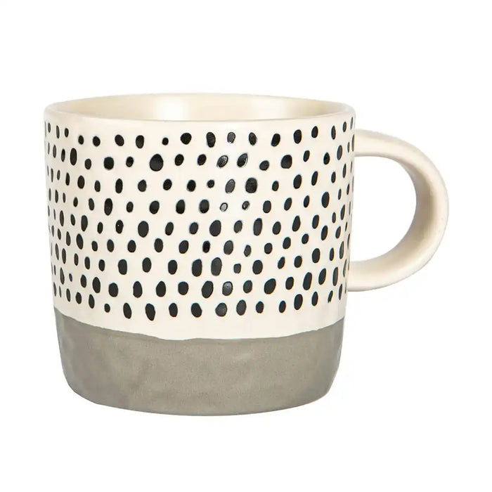 Mug with black dot pattern and gray base on a white background