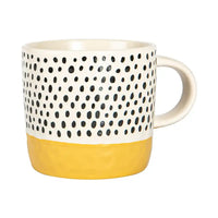 Mug with black dot pattern on white background