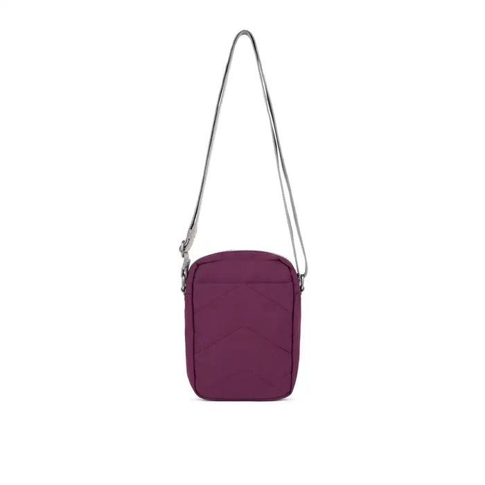 Purple crossbody bag with a strap on a white background